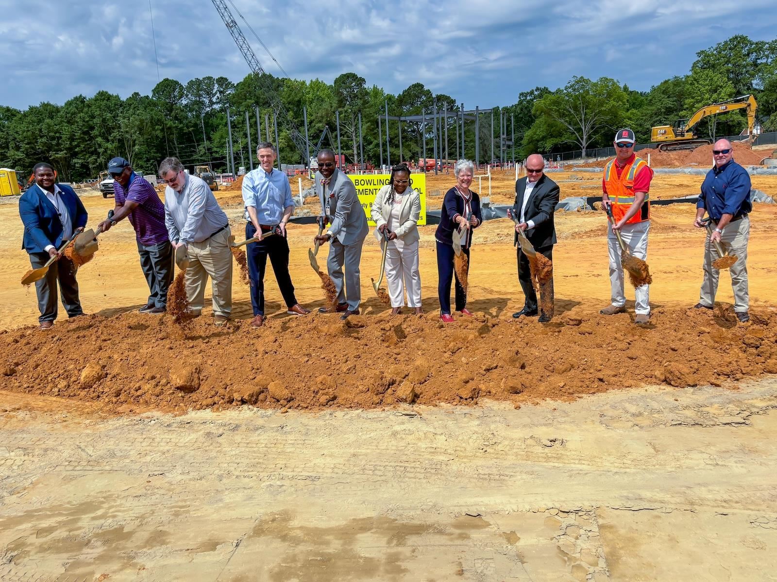 Local leaders turn over dirt at the groundbreaking ceremony